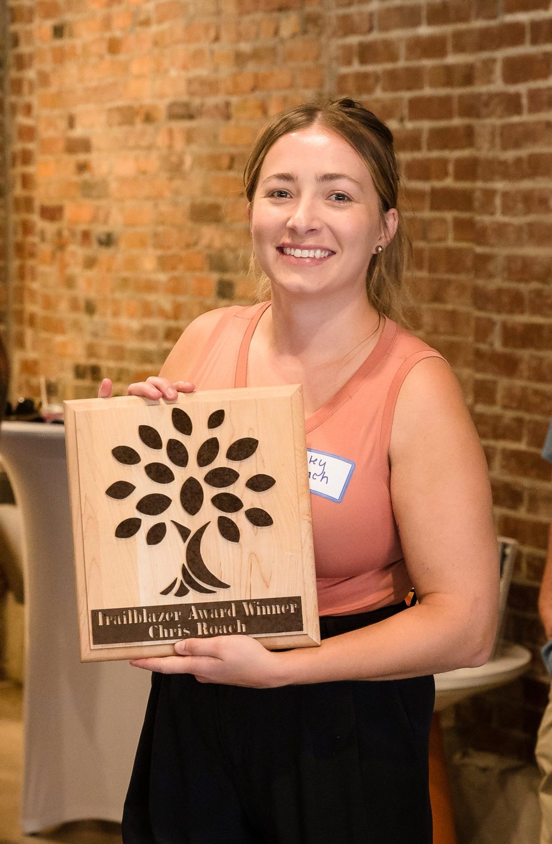 Haley Roach accepts the award on behalf of her father, Chris Roach